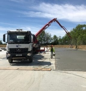 Laying ready-mix concrete using a boom pump in Kent